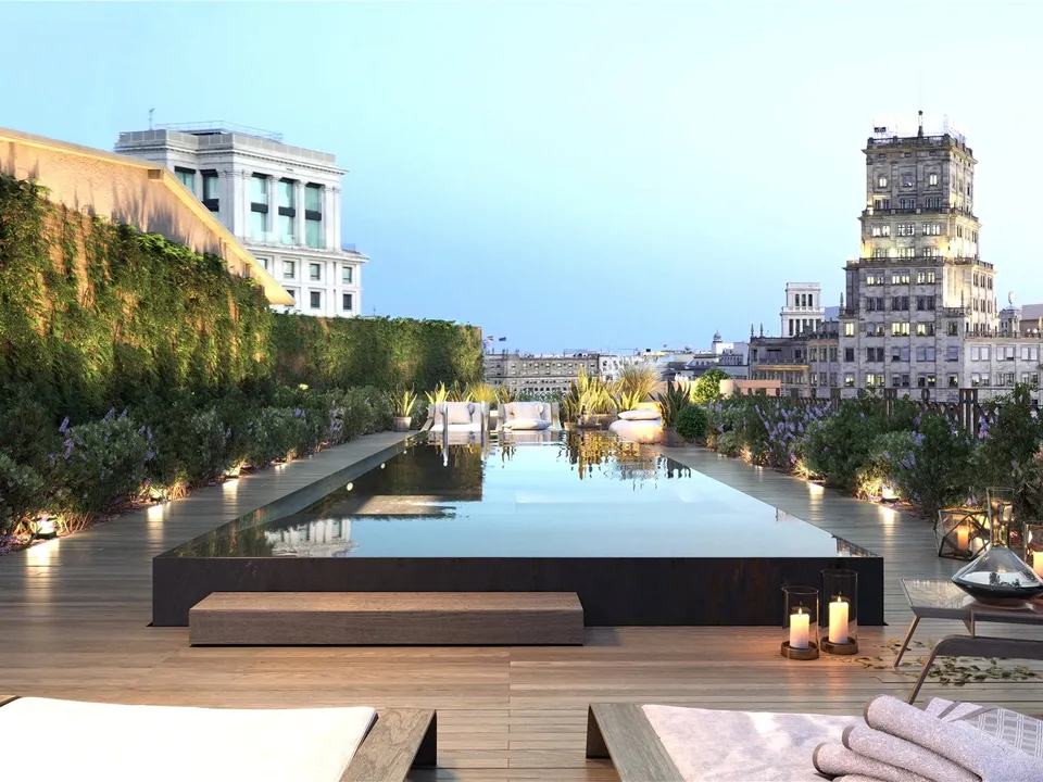 charming rooftop pool with views of the city at sunset